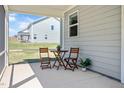 Charming covered patio features outdoor seating, offering a cozy space to relax and enjoy the surroundings at 234 Robert Howe Dr, Fuquay Varina, NC 27526