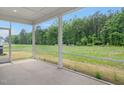 Screened porch offers serene views of the backyard and surrounding greenery, perfect for relaxing outdoors at 234 Robert Howe Dr, Fuquay Varina, NC 27526