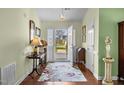 Inviting entryway with hardwood floors, a floral rug, and a view to the exterior at 2424 Cambridge Rd, Burlington, NC 27215