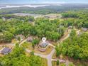 Wide aerial view showcasing the home's location within a serene, wooded neighborhood and its surroundings at 251 Gentry Dr, Pittsboro, NC 27312