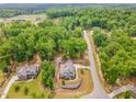 Expansive aerial view of home showcasing its location amongst lush greenery and neighborhood streets at 251 Gentry Dr, Pittsboro, NC 27312