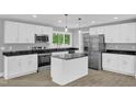 Modern kitchen with granite countertops, stainless steel appliances, and white cabinetry at 2710 E Greensboro Chapel Hill Rd, Snow Camp, NC 27349