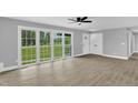 Bright living room with large windows and new floors, perfect for entertaining at 2710 E Greensboro Chapel Hill Rd, Snow Camp, NC 27349