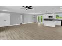 Spacious living room boasts new floors, neutral paint, and modern ceiling fan at 2710 E Greensboro Chapel Hill Rd, Snow Camp, NC 27349