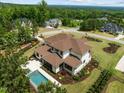 Aerial view of the beautiful home with a backyard pool, landscaped yard and community at 30 Futrell Ridge Ct, Chapel Hill, NC 27517