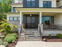 Inviting front entrance with stone steps, modern front door, and stylish accents at 30 Futrell Ridge Ct, Chapel Hill, NC 27517