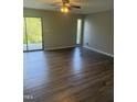Bright living room with laminate flooring, ceiling fan and sliding door access to exterior at 3049 Huntleigh Dr, Raleigh, NC 27604