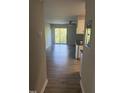 View from hallway to a living room with sliding door access to a balcony or patio at 3049 Huntleigh Dr, Raleigh, NC 27604
