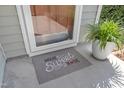 Welcoming front door with a 'Home Sweet Home' doormat and potted plant at 3608 Deering Dr, Raleigh, NC 27616