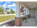 Spacious front porch with brick columns, offering a comfortable and relaxing outdoor space at 3608 Deering Dr, Raleigh, NC 27616