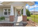 Inviting front porch with brick columns, offering a warm welcome to the home at 3608 Deering Dr, Raleigh, NC 27616