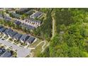 Aerial view of community, showcasing the neighborhood layout, surrounding greenery, and proximity to nature at 4009 Reunion Creek Pkwy, Apex, NC 27539