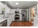 Well-lit kitchen with stainless steel appliances and quartz countertops at 5713 Timber Ridge Dr, Raleigh, NC 27609