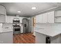 Updated kitchen showcasing modern stainless steel appliances and white cabinetry at 5713 Timber Ridge Dr, Raleigh, NC 27609