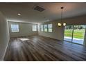 Bright living room with plenty of natural light and sliding glass doors leading to the backyard at 580 Thomas Gage Dr, Fuquay Varina, NC 27526