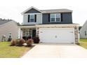 Two story home with an attached two car garage and a wide driveway at 608 Crackling Ct, Zebulon, NC 27597