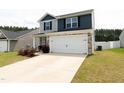Attractive two-story home with a two-car garage, manicured lawn, and convenient driveway at 608 Crackling Ct, Zebulon, NC 27597