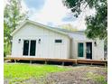 Modern home with plank siding and large sliding glass doors leading to a wooden deck at 614 Henry St, Rocky Mount, NC 27803