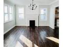 Spacious living room with hardwood floors, a decorative fireplace, and ample natural light at 614 Henry St, Rocky Mount, NC 27803