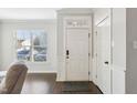Inviting foyer with hardwood floors, white trim, and natural light streaming through a window at 6323 Pesta Ct, Raleigh, NC 27612