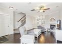 Open-concept living space featuring hardwood floors, fireplace, and staircase leading to the upper level at 6323 Pesta Ct, Raleigh, NC 27612