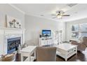 Bright living room with a fireplace, dark floors, neutral paint and ample natural light at 6323 Pesta Ct, Raleigh, NC 27612