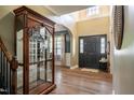 Inviting foyer with high ceilings, dark front door, and wood-look flooring at 6901 Rex Rd, Holly Springs, NC 27540