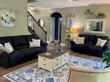 Cozy living room with stylish furnishings, including plush sofas, a patterned rug, and elegant decor at 6901 Rex Rd, Holly Springs, NC 27540