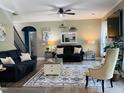 Comfortable living room featuring a ceiling fan, modern decor, and neutral tones, creating a welcoming atmosphere at 6901 Rex Rd, Holly Springs, NC 27540