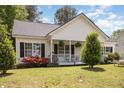 Attractive home featuring a welcoming front porch and beautiful landscaping, perfect for curb appeal at 722 E Pine Ave, Wake Forest, NC 27587