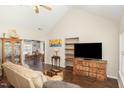 Open-concept living room showcasing hardwood floors, ample natural light, and seamless flow to the dining area at 722 E Pine Ave, Wake Forest, NC 27587
