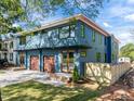 Stunning two-story home with three-car garage, modern design, blue siding, and a well-manicured lawn at 805 Tower St # 102, Raleigh, NC 27607