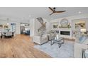Bright, open-concept living room with a modern fireplace, stylish seating, and hardwood floors at 805 Tower St # 102, Raleigh, NC 27607
