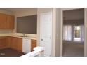 Open kitchen with wood cabinets, modern appliances, and an opening looking into the spacious living area at 8511 Bright Loop, Raleigh, NC 27613