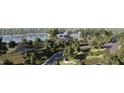 Scenic aerial view of the community showcasing mature trees, winding roads, and a tranquil lake at 194 Charlotte Knoll St # 10, Zebulon, NC 27597
