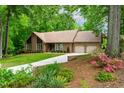 Attractive brick home boasting a long driveway, lush landscaping, and blooming azaleas, creating a welcoming entrance at 101 Easton Ct, Garner, NC 27529