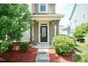 Inviting front porch with detailed door and well-maintained landscaping at 1013 Oatney Ridge Ln, Morrisville, NC 27560