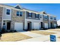 Attractive townhomes featuring attached garages, neutral color schemes, and landscaping throughout the community at 106 S Chubb Rdg, Wilson's Mills, NC 27520
