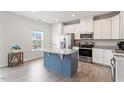 Bright kitchen features white cabinets, stainless steel appliances, granite countertops, and a contrasting kitchen island at 1073 Branch Line Ln, Apex, NC 27502