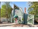 Charming green home featuring a unique roofline, complemented by a brick pathway leading to a quaint front door at 1112 Western Ave, Rocky Mount, NC 27804