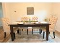 Elegant dining room featuring a dark wood table with four upholstered chairs and decor at 1145 Raven Perch Dr, Wendell, NC 27591