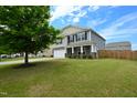 Attractive two-story home with a well-manicured lawn and a welcoming front porch at 1145 Raven Perch Dr, Wendell, NC 27591