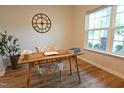 Bright office with a large window, a bamboo desk with an open notebook, and decorative plants at 1145 Raven Perch Dr, Wendell, NC 27591