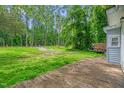 Exterior view featuring a rustic wooden deck and spacious grassy backyard perfect for outdoor activities at 1219 Junction Rd, Durham, NC 27704