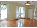 Inviting living room featuring hardwood floors, neutral walls, ceiling fan, and bright natural light at 122 E Orange St, Hillsborough, NC 27278