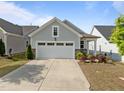 Charming single-story home features a two-car garage, manicured landscaping, and concrete driveway at 140 Azure Mist Dr, Raleigh, NC 27610