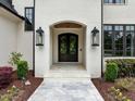 Elegant front entrance with stone walkway, custom door and manicured landscaping at 1416 Bailey Hill Dr, Raleigh, NC 27614
