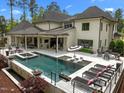 Luxury home featuring a stunning pool, spa, and outdoor dining area with covered seating and an outdoor kitchen at 1416 Bailey Hill Dr, Raleigh, NC 27614
