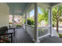 Relaxing covered porch featuring classic columns, a swing, and views of the lush surroundings at 1416 Heritage Links Dr, Wake Forest, NC 27587