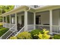 Inviting covered porch with classic columns, ample seating, and a serene, relaxing atmosphere at 1416 Heritage Links Dr, Wake Forest, NC 27587